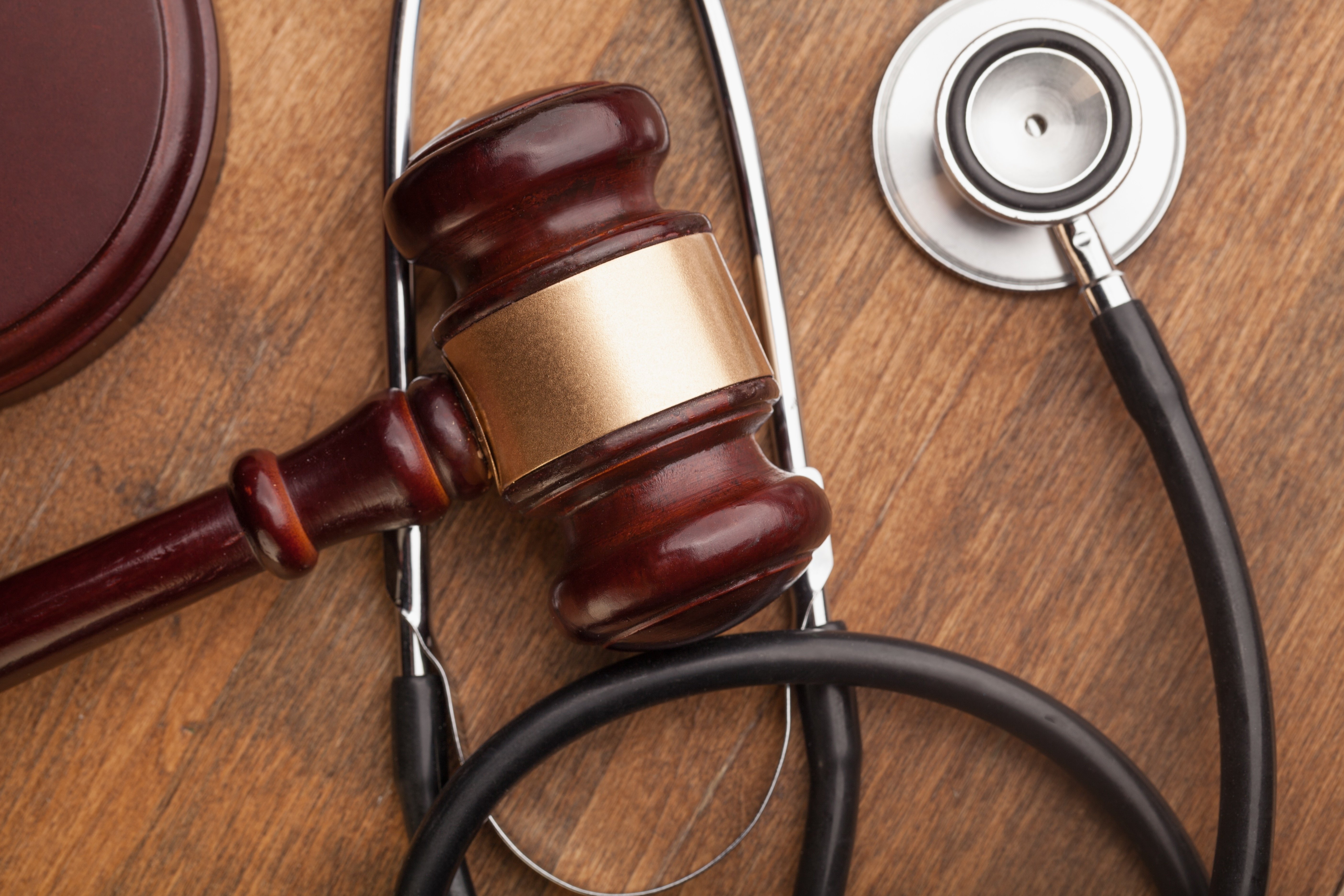 An image of a gavel sitting on top of a stethoscope representing medical malpractice.
