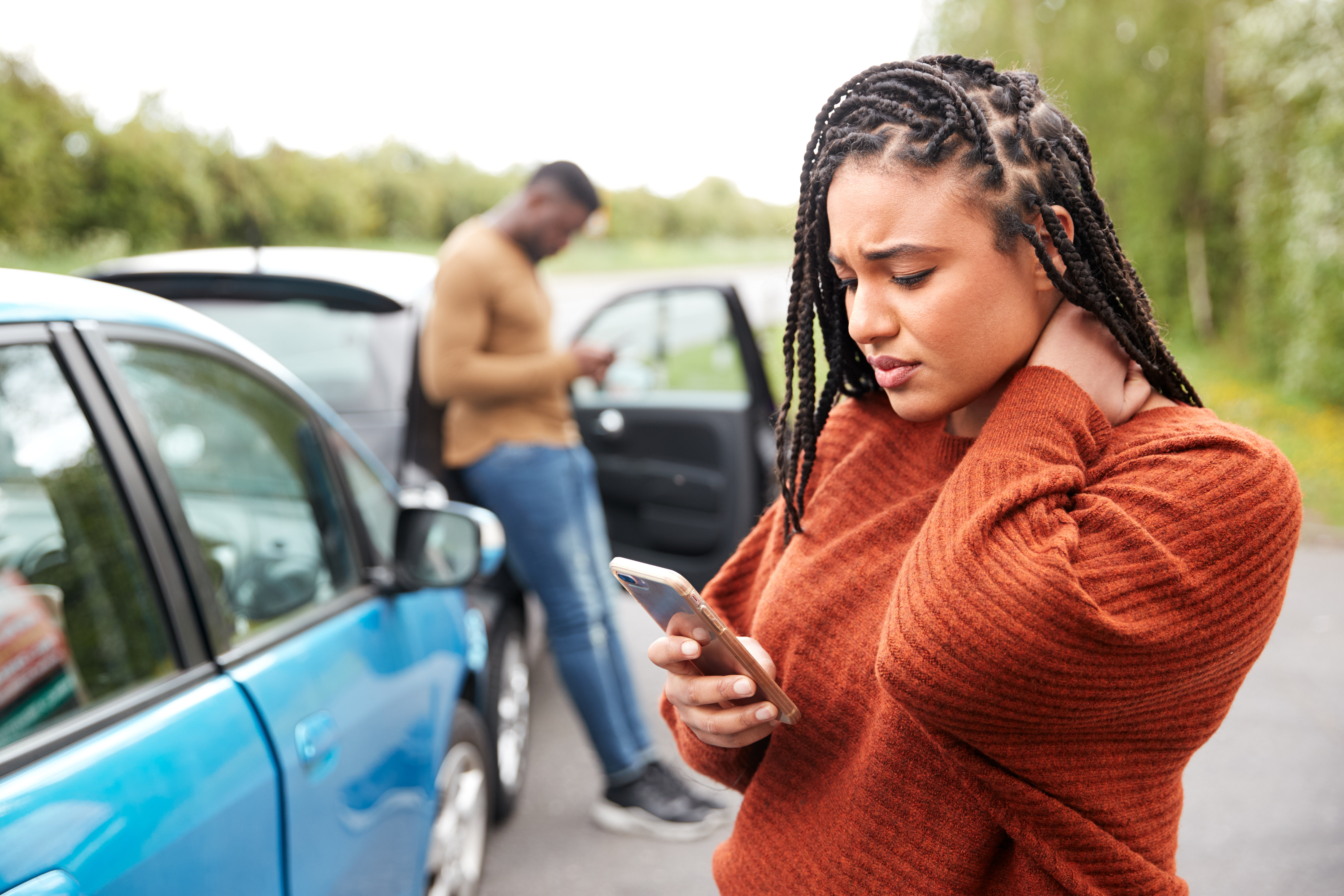 An image of a woman holding her neck after a car accident in need of a personal injury lawyer in Greenville, NC.