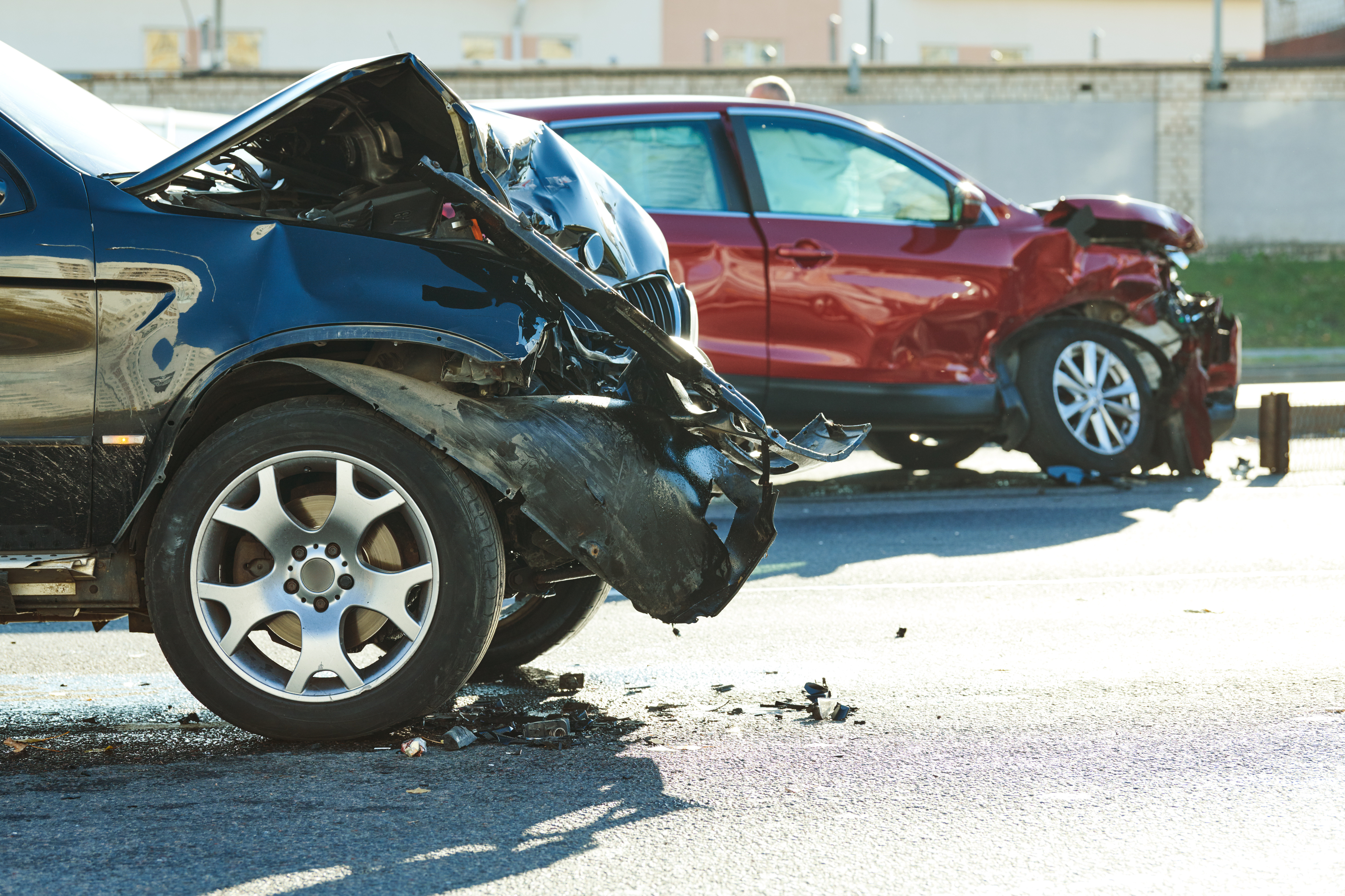 An image of two cars that have sustained damage from a car accident.