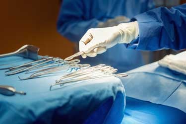 surgeon using surgical tools
